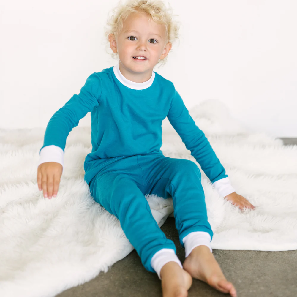 A child wears incontinence pyjamas in mosaic blue